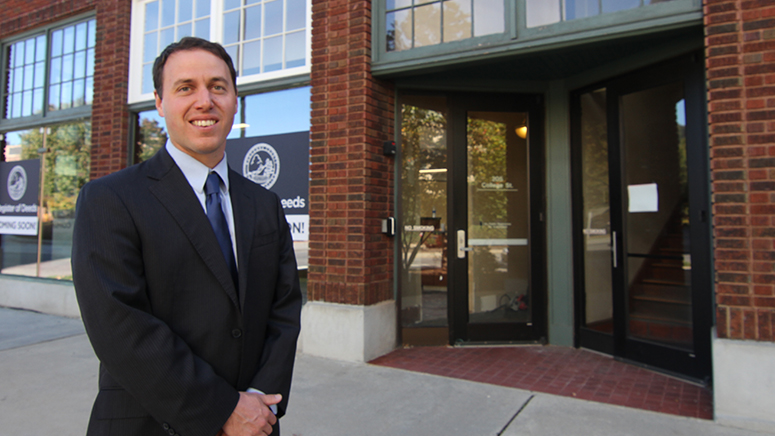 Register of Deeds have moved. Register of Deeds Drew Reisinger standing outside their new location.