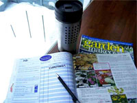 Photo of a gardening magazine open with a pen on it.