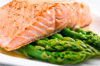 Photo of grilled salmon over asparagus.
