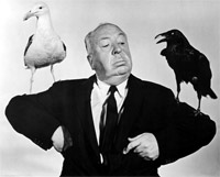 Photo of Alfred Hitchcock with a bird on each arm.