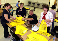 Left to right: Campaign organizers Lindsay Carver, Lori Brown, Randy Sorrells and Sheri Banks work alongside other Partnership for Substance-free BC volunteers to stuff 10,500 drug drop-off bags with instructional flyers. Adults are urged to use the bags to drop off unnecessary medications Friday, June 1, by 1pm at any BC Middle or High School, or by noon @ Asheville Middle or Asheville High.