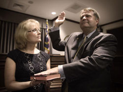 David Gantt gets sworn in as Buncombe County Commission Chair. His wife, Charise holds the Bible.