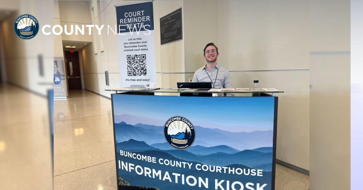 a man sits at an information kiosk in the courthouse