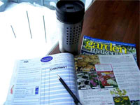Photo of a gardening magazine open with a pen on it. 