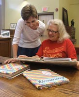 Roberta E. Newman presents the first three Womansong scrapbooks to NC Collection librarian Ann Wright.