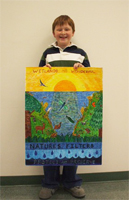 Photo of young boy holding an example of a poster submission.