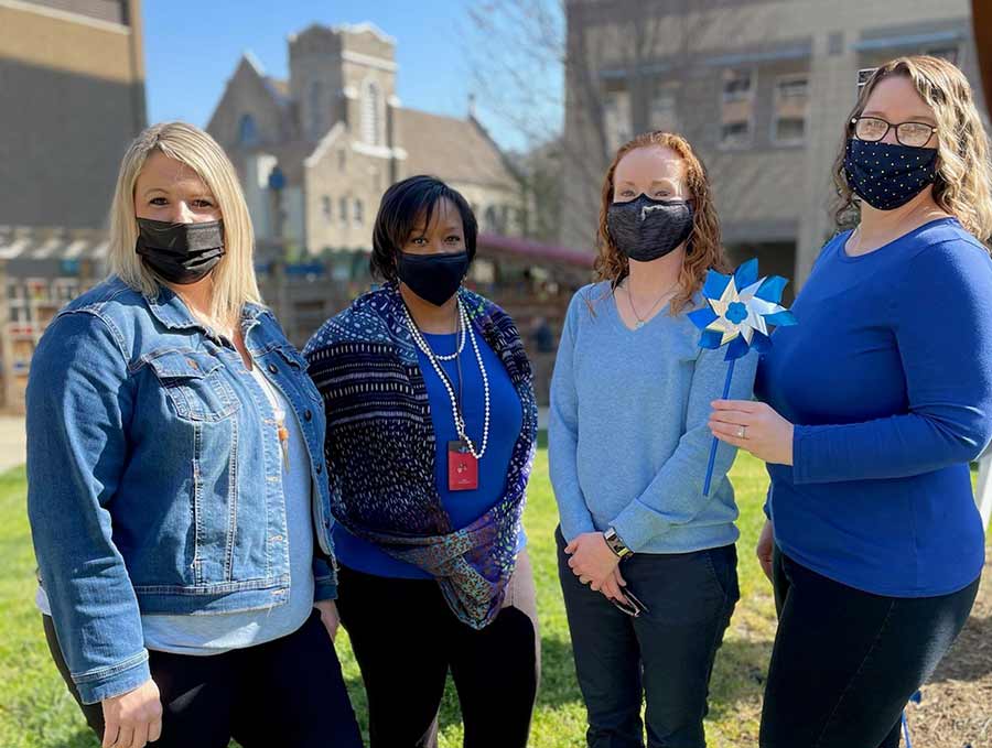 social workers hold pinwheels