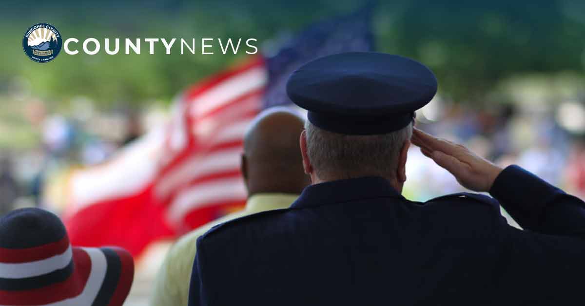 a man in uniform salutes the flag