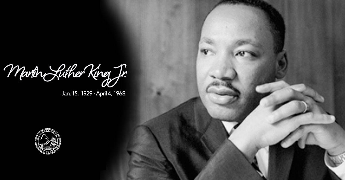 A black and white photo of Dr. Martin Luther King Jr. with the dates of his birth and death.