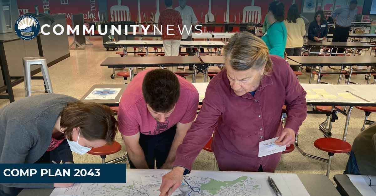 community members look at a map at a comp plan meeting