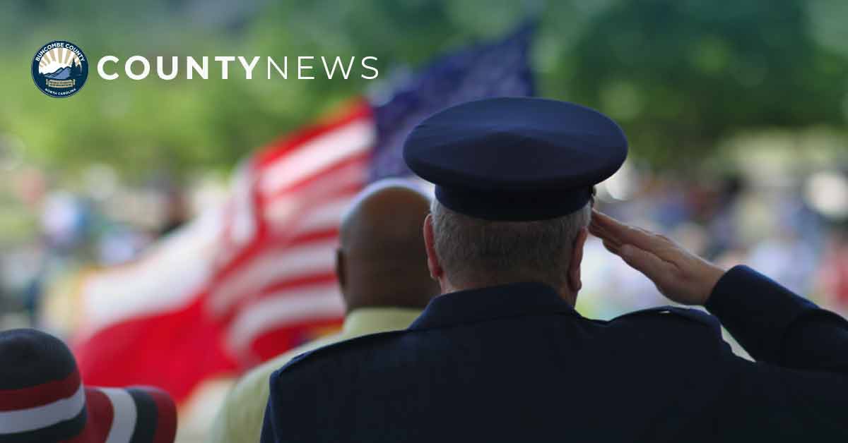 a man salutes the flag at a veterans day ceremony