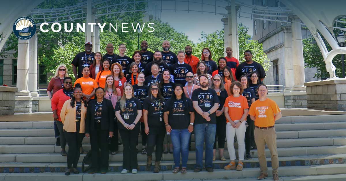 a group photo of Buncombe employees wearing orange for gun violence awareness