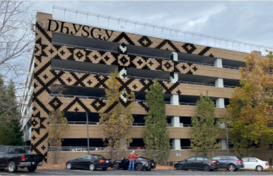 a parking garage with an indigenous mural 