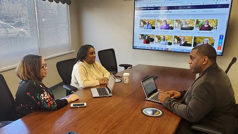 Picture of employees meeting in an office setting