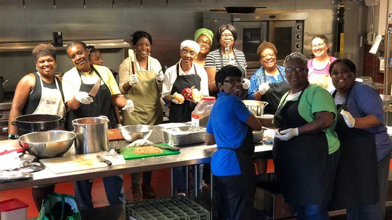 Picture of women gathering in a kitchen